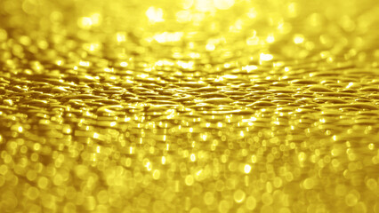 Golden yellow light glitter bokeh of sunlight refection on the morning dew on the car roof. Texture background of water droplets. Beautiful nature glittering light backdrop. Luxury backgrounds.