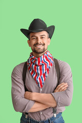 Handsome cowboy on green background