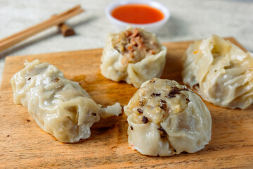 Dim sum with various fillings, from chicken, carrots, mushrooms and shrimp served with sauce.