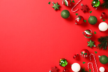 Christmas flat lay composition. Red background with Xmas balls ornaments. Perfect for holiday...