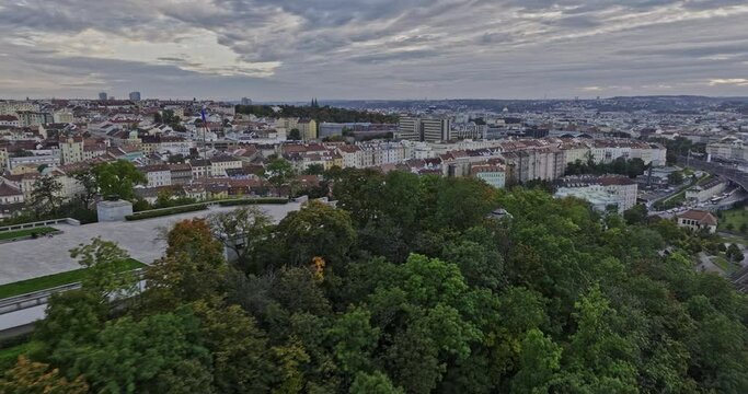 Prague Czechia Aerial v87 fly around Vitkov hill park, capturing hilltop national memorial on stone platform ringed by woods surrounded by panoramic cityscape - Shot with Mavic 3 Cine - November 2022