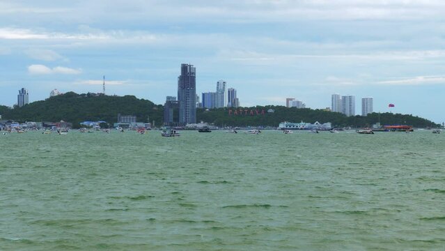 A view of the marina and business center of Pattaya Beach from across the gulf, where hotels, condominiums, boats, jetski, and shopping centers are located, in Chonburi province, Thailand.