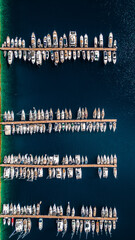 Marina in the Mediterranean Sea, moored boats in a row, top view, photograph from a drone