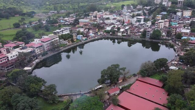 Cinematic aerial view of sacred Gautam Lake near the Trimbakeshwar Temple in Trimbak City, Nashik, Maharashtra, India