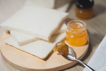 Breakfast with bread and jam on the wooden table