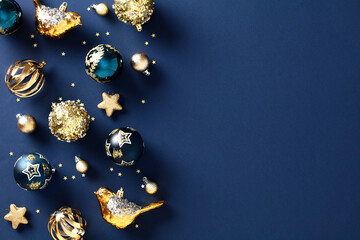 Elegant Christmas card featuring golden decorations, glittering stars, ornaments on navy blue background Perfect for holiday celebrations, this stylish and festive design creates a luxury atmosphere