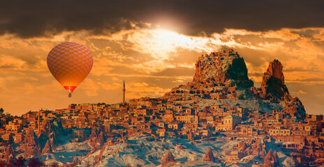 Hot air balloon flying over spectacular Cappadocia at dusk - Goreme, Turkey