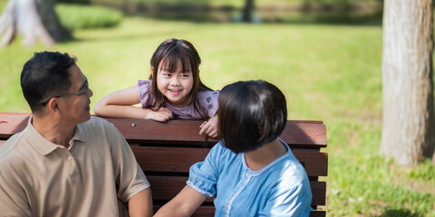 Grandparent playing togetherness with a granddaughter in the park in the morning. Family, love and...