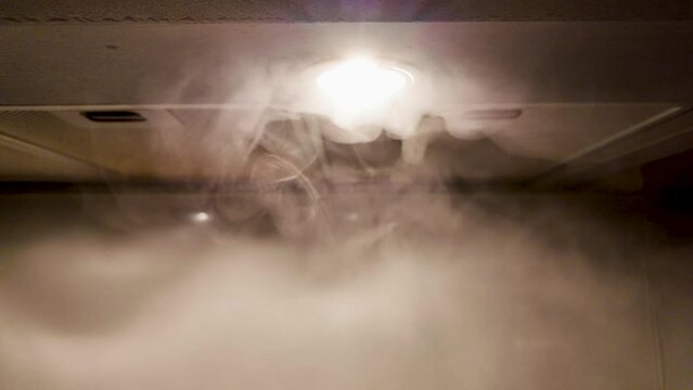Slow motion of smoke on a kitchen hood