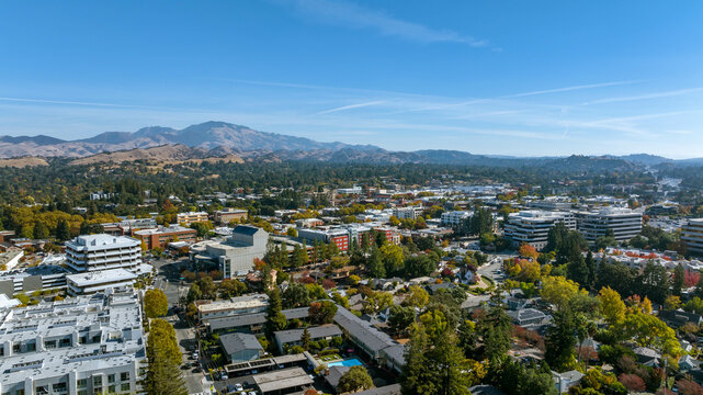 Aerial image over downtown Walnut Creek with businesses, houses and a blue sky