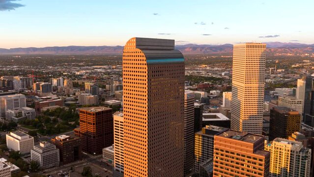 Iconic Wells Fargo Center in Denver at sunset, aerial riser hyperlapse