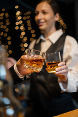 Barwoman pouring whiskey whiskey glass..