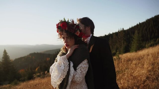 Authentic wedding couple walking through the mountains in autumn at sunset.Wedding concept in the mountains.Cinematic frame 4k