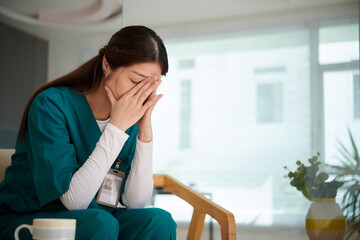 Young nurse crying after difficult day at work