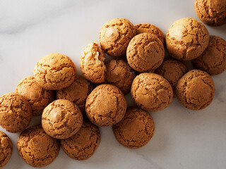 pile of cookie amaretti on white marble background - traditional Italian Sardinian pastry....