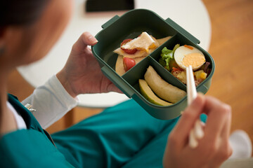 Medical nurse eating lunch she prepared at home, view from above