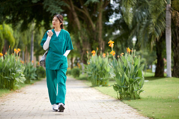Young medical intern in uniform walking to hospital in the morning