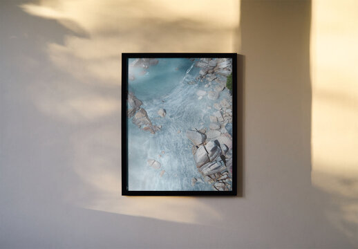 Mockup of vertical customizable A3 / A4 picture frame mounted on wall