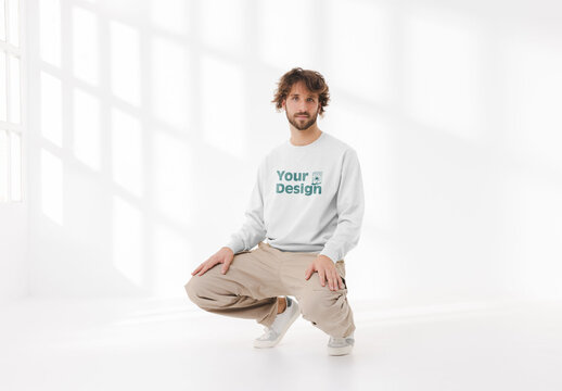 Mockup of man wearing customizable sweatshirt crouching