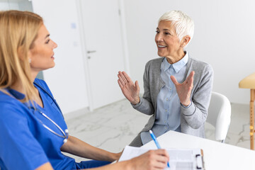 Healthcare and medical concept - doctor with patient in hospital. Doctor working in the office and listening to the patient, she is explaining her symptoms, healtcare and assistance concept