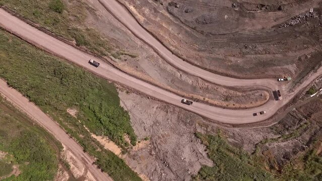 Overhead Drone View of Trucks Hauling Dirt Away From Siana Glod and Silver mine, Mainit, Philippines