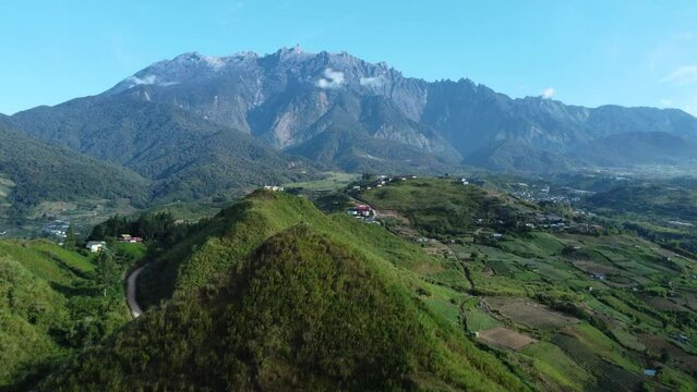 Beautiful Drone shot of the fields of Kundasnag showing Mount Kinabalu in the background Sabah Malaysia daylight