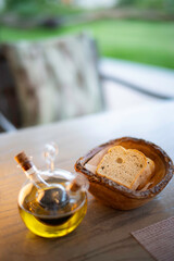 slice of bread with olive oil on table with blurry background