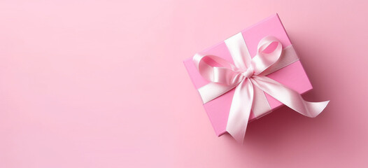 Gender reveal party concept, Top view photo of pink giftbox with white ribbon bow on isolated pastel pink background with copyspace