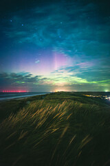 Northern lights over the dunes of denmark. High quality photo 