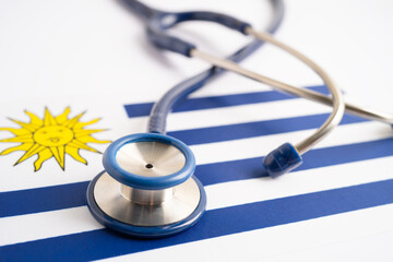 Stethoscope on Uruguay flag background, Business and finance concept.