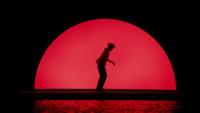 Dancing Silhouette On Red Stage