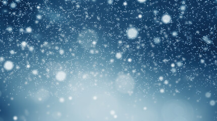 Fototapeta premium Snowfall against a blurred blue background.