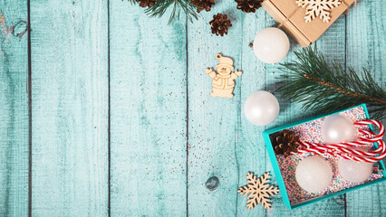 New Year banner with Christmas gift boxes and decorations on light blue wooden background.
