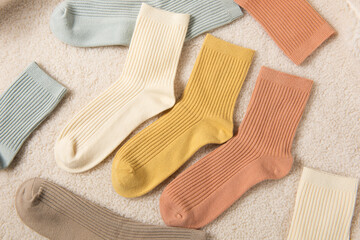 Colorful socks laid out on plush blanket background
