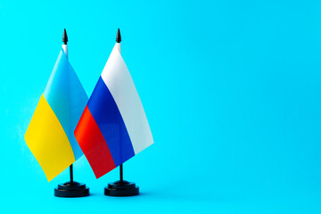 Small flags of Russia and Ukraine on flagpoles