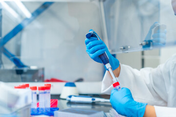 Scientist making a test tube in a laboratory using pipette