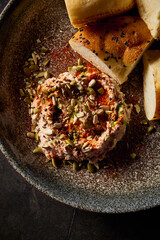 Vertical close-up showcasing the rich details of hummus and Uzbek tandoor bread, an emblem of...