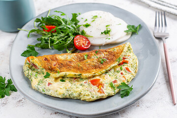 Omelette with tomatoes and salad on plate. Frittata - italian omelet. Keto, ketogenic diet.