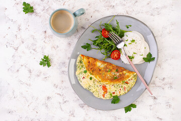 Omelette with tomatoes and salad on plate. Frittata - italian omelet. Keto, ketogenic diet. Top view