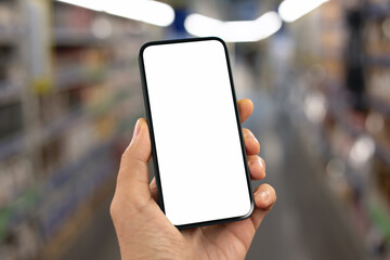 man hand hold phone with isolated screen background shelves in supermarket