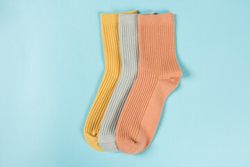 Colorful socks laid out on blue background