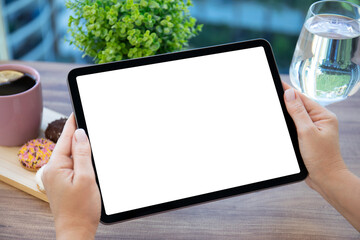 female hands holding computer tablet with isolated screen in cafe