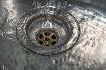 water flowing from a faucet in sink 