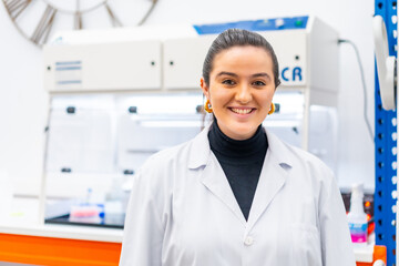 Young scientist standing smiling in a laboratory