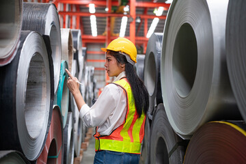 Portrait of women staff worker Standing counting and inspecting products in the metal sheet warehouse.