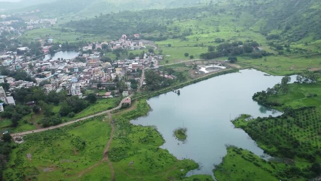 Aerial view of famous tourist attraction Ahilya Dam with the view of Trimbakeshwar town during monsoon, Nashik, Maharashtra, India
