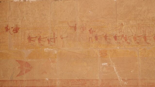 colorful hieroglyphs line the wall of ancient temples and tombs in the valley of the kings and hatshepsut temple