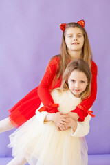 two girls pose on a purple background