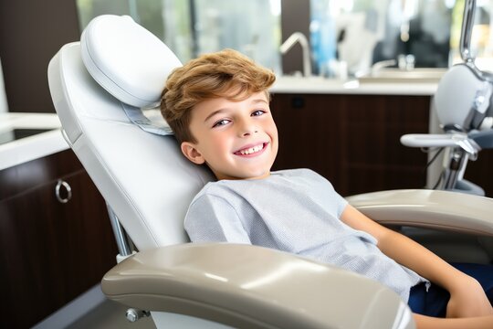 Smiling young boy in dentist chair with a smile on his face.