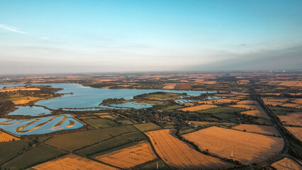 Aerial view 4k of Rutland water in England during sunset in mid Summer.